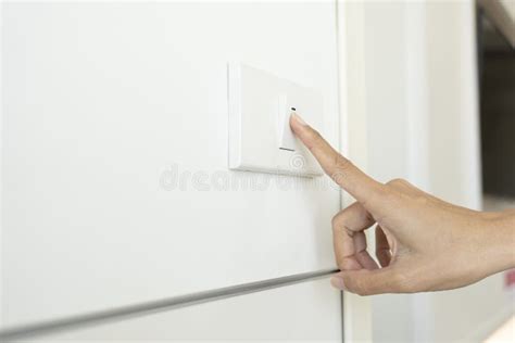 Woman Turning Off Light Switch in a Home Stock Photo - Image of ...