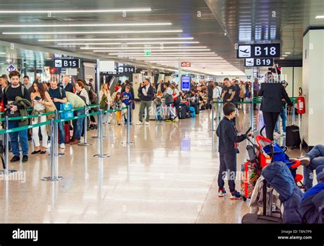 Crowd Of People Waiting In Line To Check In At An Airport Transport