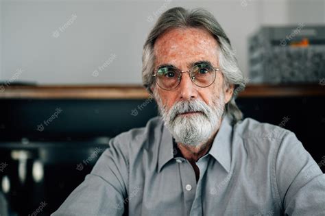 Premium Photo Portrait Of Senior Man With Grey Hair And Beard Sitting