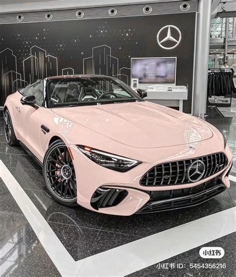 A Pink Sports Car Is On Display In A Showroom