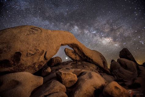 The Milky Way And Venus Rise Behind Arch Rock In Joshua Tree National