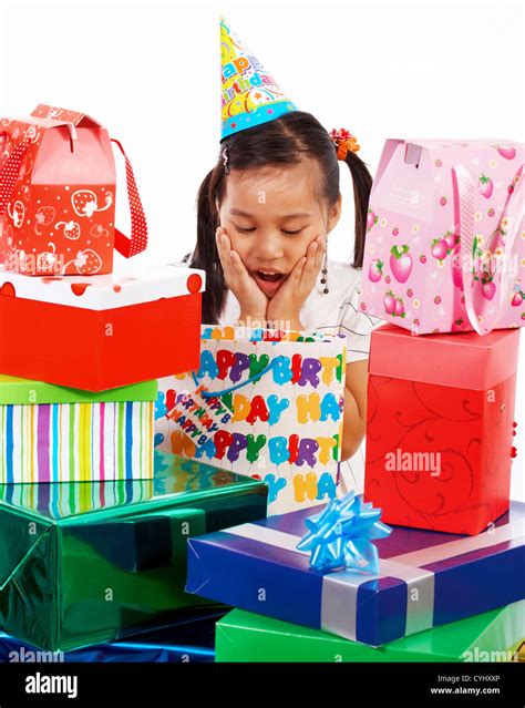 Girl Excited On Her Birthday As She Receives Many Gifts Stock Photo - Alamy