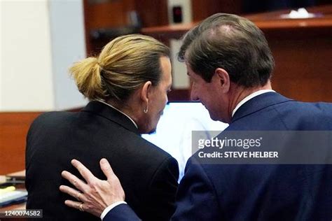 US actor Johnny Depp speaks to his attorney Ben Chew in the courtroom ...