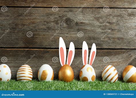 Decorated Easter Eggs And Cute Bunny S Ears On Green Grass Against