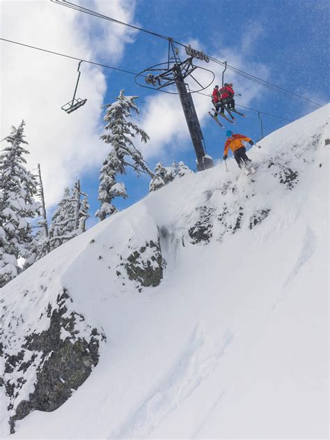 Dropping A Cliff Beneath Chair 2 At Alpental As Two Onlooking