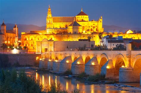 Premium Photo Night Mezquita And Roman Bridge In Cordoba Spain