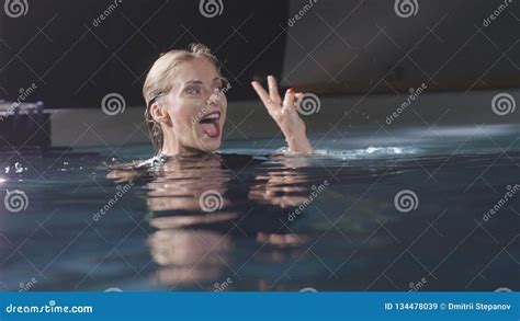 Smiling Woman Gesturing And Posing For Photo Or Video In Swimming Pool