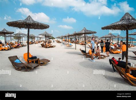 Sir Bani Yas Uae 5 January 2024 A Serene Beach Setting With Thatched Umbrellas And Loungers