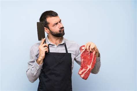 Premium Photo Chef Holding A Raw Meat Thinking