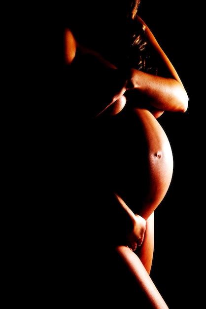 Premium Photo Midsection Of Naked Pregnant Woman Standing Against