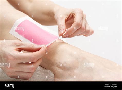 Woman Using Pink Wax Strips Beautiful Woman Doing Depilation For Her Legs With Waxing Isolated