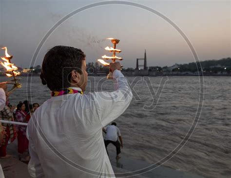 Image Of Priest Performing Haarthi Or Aarthi To Holy River Ganges In