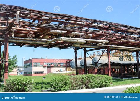 A Large Metallic Iron Pipeline Trestle With Pipes And Wires For