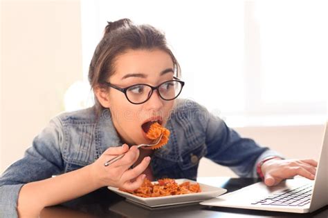 Young Woman Eating Delicious Pasta While Using Laptop Indoors Stock Image - Image of gourmet ...