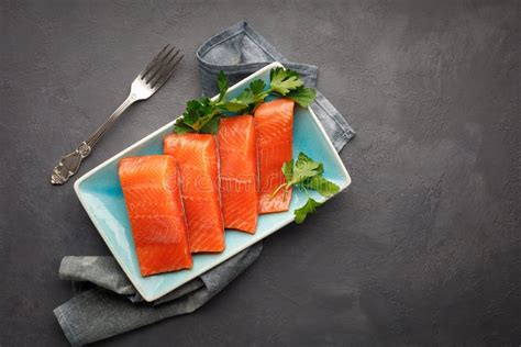 Fresh Raw Red Salmon Fish Fillet With Herbs Black Stone Background