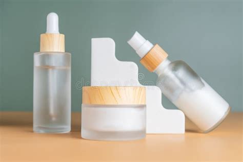 Set Of Cosmetic Products In Frosted Glass Bottles On Cocnrete Podiums