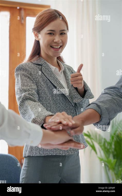 Group Of Business People Putting Their Hands Working Together On Wooden