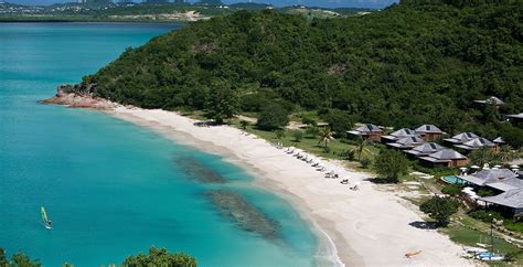 An Aerial View Of The Beach And Surrounding Resort Buildings With