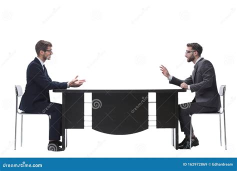 Two Business People Discussing Something Sitting At The Table Stock