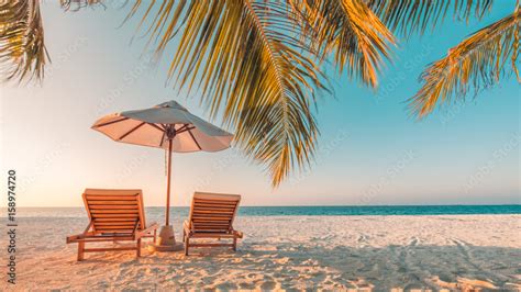 Beautiful beach. Chairs on the sandy beach near the sea. Summer holiday ...