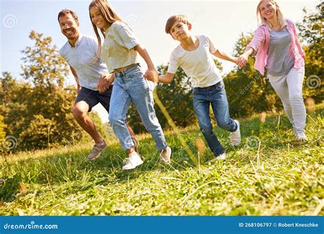 Parents and Two Children Walk Hand in Hand Stock Image - Image of ...