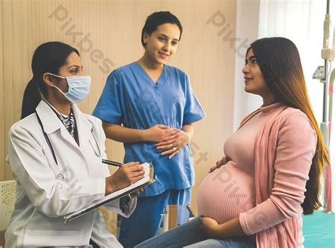 A Pregnant Woman Is Taking Advice Of A Female Doctor During Pregnancy Photo  Free Download