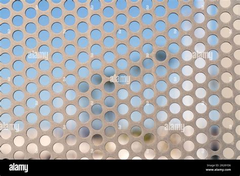 Close Up Of A Perforated Metal Sheet With Scratches On A Fence Stock