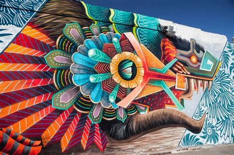 An Elephant Painted On The Side Of A Building With Large Colorful