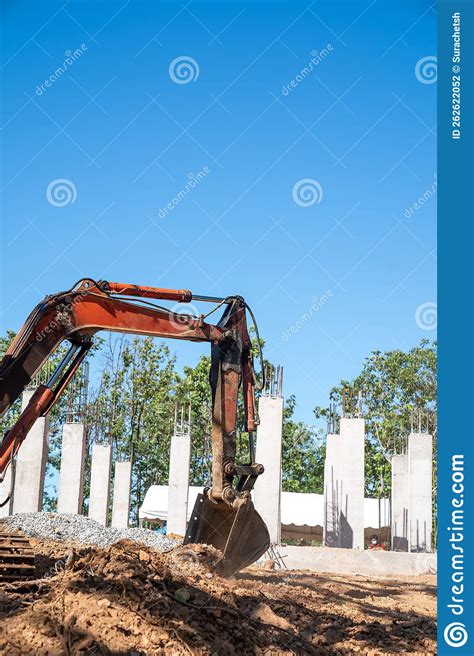 Hydraulic Excavator Is Digging Soil At A Construction Site Surrounded