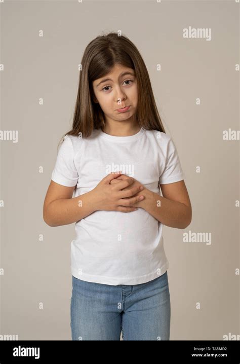 Portrait Of A Cute Young Shy Girl Looking Sorry And Timid At The Camera Asking For Forgiveness