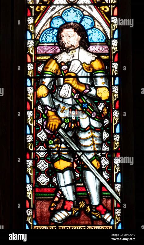 Stained Glass Window Of A Medieval Knight Holding A Sword In The Chapel At Sudeley Castle Stock