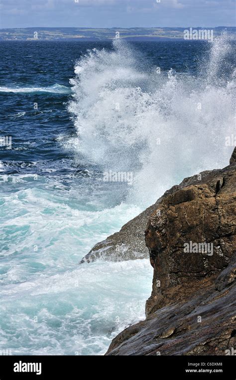 Waves Crashing Into Rocks Of Cliff Along The Brittany Coast France