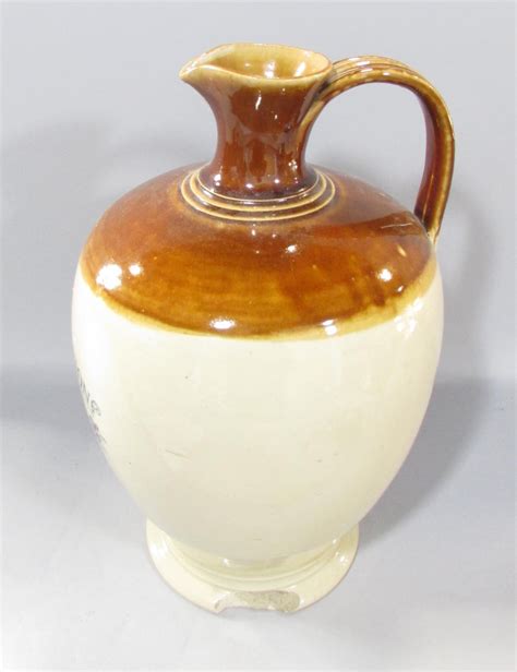 A Glazed Stoneware Ewer For P D Perfection Scotch Whisky By Peter