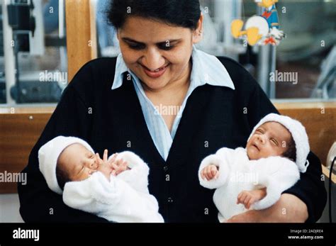 MODEL RELEASED Mother Holding Her Newborn Twins Stock Photo Alamy