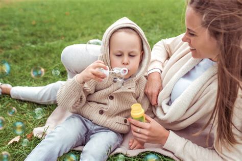 Mom Woman Plays With Child Little Boy Son Autumn Street Blowing Soap