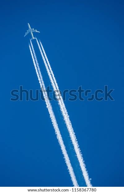 Aircraft Flying High Altitude Contrails Stock Photo 1158367780