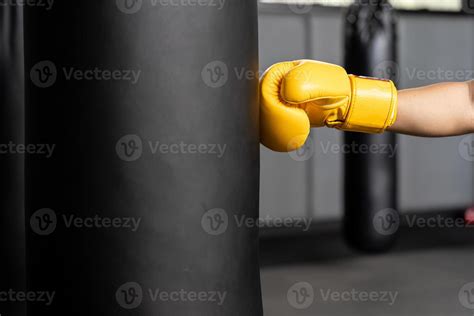 punching bag wearing yellow boxing gloves. copy space 11547968 Stock ...