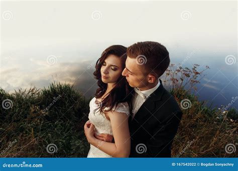 Stylish Luxury Bride And Groom Hugging Tender And Posing In Soft Light