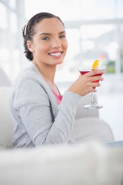 Premium Photo Happy Woman Sitting On Sofa And Holding Cocktail