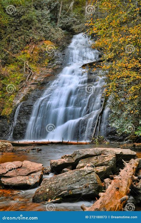 Majestic Waterfall Cascading Down A Rocky Mountainside Surrounded By