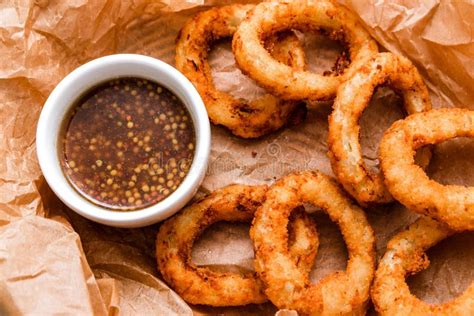 Breaded Onion Rings With Sauce Served In A Wicker Basket On Craft