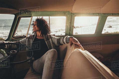 African Woman Sitting In A Van And Relaxing Young Female On Road Trip