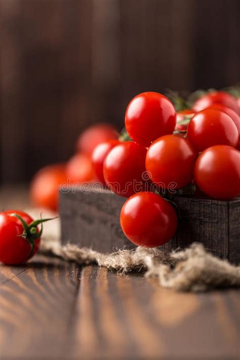 Small Red Cherry Tomatoes On Rustic Background Cherry Tomatoes On The