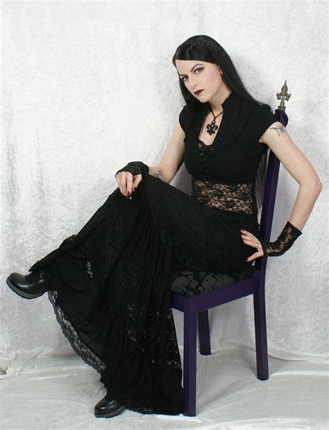 Brunette Gothic Girl Wearing Black Long Dress And Black Shoes