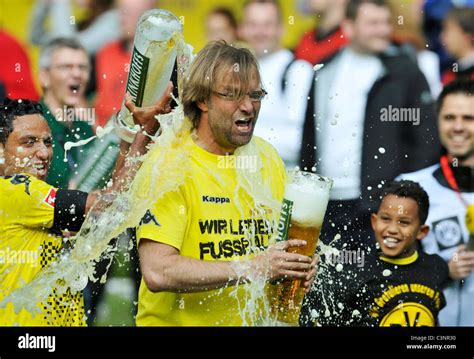 Dortmund coach manager Juergen Klopp gets showered with beer during ...