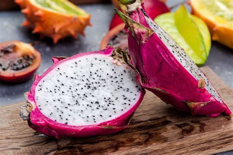 Pitahaya Or Dragon Fruit Cut In Half On Board Fresh Raw Exotic Fruits