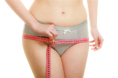 Woman In Lingerie Measuring Her Hips With Measure Tape Stock Image