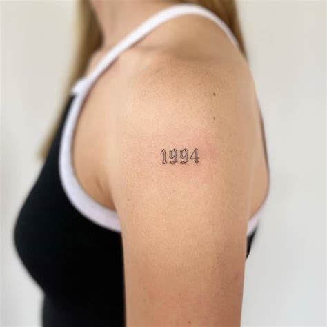 1994 Lettering Tattoo Located On The Upper Arm