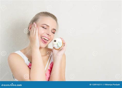 Pleased Blonde Girl Having Fun With A Sweet Dessert With Butter Stock
