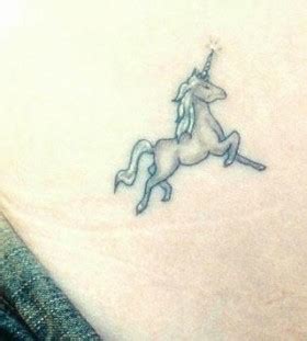 White and black unicorn tattoo